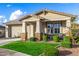 Charming single-story home with a well-manicured lawn and a two-car garage at 11366 W Ashby Dr, Peoria, AZ 85383