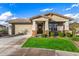 Attractive one-story home with beautiful landscaping, a front porch, and a well-maintained lawn at 11366 W Ashby Dr, Peoria, AZ 85383