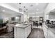 Modern kitchen with granite countertops and stainless steel appliances open to living spaces at 11366 W Ashby Dr, Peoria, AZ 85383