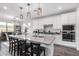 Bright kitchen featuring white cabinets, granite countertops, a kitchen island with seating, and pendant lighting at 11366 W Ashby Dr, Peoria, AZ 85383