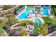 Overhead shot of a community pool area with water slide, mature landscaping, and ample seating at 11366 W Ashby Dr, Peoria, AZ 85383