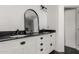 Elegant bathroom featuring dual sinks, black granite countertop, and stylish vanity at 11474 N 79Th Dr, Peoria, AZ 85345