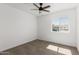 Neutral bedroom with a ceiling fan and natural light from the window at 11474 N 79Th Dr, Peoria, AZ 85345