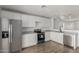 Modern kitchen featuring stainless steel appliances, white cabinets, and updated countertops at 11474 N 79Th Dr, Peoria, AZ 85345