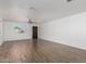 Open living room featuring wood-look flooring, a ceiling fan, and a bright window at 11474 N 79Th Dr, Peoria, AZ 85345