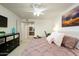 Bright bedroom with a ceiling fan, fresh white walls, and a glimpse into the adjacent kitchen space at 12212 N Paradise Village S Pkwy # 136, Phoenix, AZ 85032