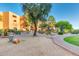 Serene desert landscaping with a brick path, leading to community seating areas at 12212 N Paradise Village S Pkwy # 136, Phoenix, AZ 85032