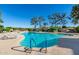 Outdoor community swimming pool surrounded by lounge chairs and landscaping at 12212 N Paradise Village S Pkwy # 136, Phoenix, AZ 85032