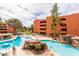 Resort-style pool area with rock features, waterfall, and lounge seating at 12212 N Paradise Village S Pkwy # 136, Phoenix, AZ 85032