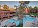 Scenic aerial view of a complex pool featuring a rock waterfall, spa and relaxing lounge areas at 12212 N Paradise Village S Pkwy # 136, Phoenix, AZ 85032