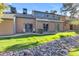 Expansive backyard with seating area, mature trees, and decorative rock landscaping at 14002 N 49Th Ave # 1029, Glendale, AZ 85306