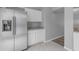 Bright kitchen with stainless steel refrigerator, white cabinetry, and granite countertops at 14002 N 49Th Ave # 1029, Glendale, AZ 85306