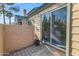 A private patio area with neutral stucco walls and a sliding glass door, perfect for relaxing outdoors at 14002 N 49Th Ave # 1029, Glendale, AZ 85306