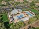 Aerial view of community center with sparkling pools, lounge areas, clubhouse, and ample parking for residents and guests at 15480 W Corrine Dr, Surprise, AZ 85379