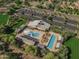 Aerial view of community center with sparkling pools, lounge areas, clubhouse, and ample parking for residents and guests at 15480 W Corrine Dr, Surprise, AZ 85379