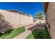 Private backyard features a block wall, low-maintenance turf and a paved patio, perfect for outdoor living at 15480 W Corrine Dr, Surprise, AZ 85379