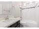 Bathroom features a white vanity, tiled shower-tub, and a decorative tile backsplash at 15480 W Corrine Dr, Surprise, AZ 85379