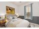 Comfortable bedroom featuring a soft bed with decorative pillows, and natural light from the window at 15480 W Corrine Dr, Surprise, AZ 85379