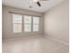 Bedroom with tile floors, neutral paint, and large windows offering plenty of natural light at 15480 W Corrine Dr, Surprise, AZ 85379