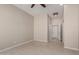 Empty bedroom with tile floors, neutral paint, and access to an adjoined hallway at 15480 W Corrine Dr, Surprise, AZ 85379