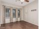 Bedroom featuring dark tile floors, neutral walls, and a window with curtains at 15480 W Corrine Dr, Surprise, AZ 85379