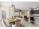 Open-concept dining room featuring a rustic wooden table, modern chandelier, and seamless transition to the living area at 15480 W Corrine Dr, Surprise, AZ 85379