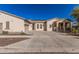 Wide driveway leading to a home with solar panels, an attached garage, and charming front porch at 15480 W Corrine Dr, Surprise, AZ 85379