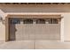 Detailed view of a garage door with decorative windows, adding architectural interest to the home's exterior at 15480 W Corrine Dr, Surprise, AZ 85379