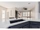 Modern kitchen featuring sleek countertops, a stainless steel faucet, and an open-concept design at 15480 W Corrine Dr, Surprise, AZ 85379