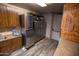 Kitchen area with wood cabinets, stainless steel refrigerator and utility appliances at 15480 W Corrine Dr, Surprise, AZ 85379