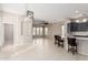 Bright living room with a ceiling fan and tile floors with a modern open concept design at 15480 W Corrine Dr, Surprise, AZ 85379