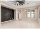 Bright living room featuring neutral walls, tile floors, and lots of natural light from the large windows at 15480 W Corrine Dr, Surprise, AZ 85379