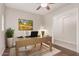 Bright home office with wooden desk, neutral walls, and a decorative rug, perfect for working from home at 15480 W Corrine Dr, Surprise, AZ 85379