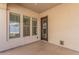 Covered patio featuring three windows and an entry door at 15480 W Corrine Dr, Surprise, AZ 85379