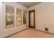 Covered patio featuring three windows and an exterior door at 15480 W Corrine Dr, Surprise, AZ 85379