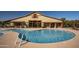 Outdoor pool with building view, restroom, and shower areas at 15480 W Corrine Dr, Surprise, AZ 85379