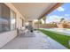 Covered back patio with outdoor seating and a view of the sparkling pool and lush landscaping at 1728 E Barbarita Ave, Gilbert, AZ 85234