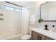 A well-lit bathroom features a modern vanity and a shower-tub combination with a curtain at 1728 E Barbarita Ave, Gilbert, AZ 85234