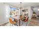 Bright dining area features views of the pool, a modern chandelier, and hardwood floors at 1728 E Barbarita Ave, Gilbert, AZ 85234