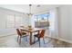 Dining area with backyard pool views and modern chandelier at 1728 E Barbarita Ave, Gilbert, AZ 85234