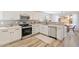 Updated kitchen featuring stainless steel appliances, tile backsplash, and wood floors at 1728 E Barbarita Ave, Gilbert, AZ 85234