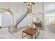 Inviting living area with staircase, front door, white walls, wood look flooring, and modern decor at 1728 E Barbarita Ave, Gilbert, AZ 85234