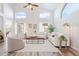 Bright living room featuring soaring ceilings, many windows, neutral decor, and wood-look flooring at 1728 E Barbarita Ave, Gilbert, AZ 85234