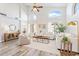 Open-concept living room featuring tall windows, neutral decor, and wood-look flooring at 1728 E Barbarita Ave, Gilbert, AZ 85234