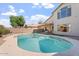 Beautiful backyard with a private pool, covered patio, and lush landscaping at 1728 E Barbarita Ave, Gilbert, AZ 85234