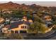 Aerial view of an upscale neighborhood, highlighting the homes' tile roofs and lush desert landscaping at 19978 N 101St Pl, Scottsdale, AZ 85255