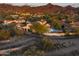 Expansive aerial perspective showing a neighborhood with private pools, well-manicured yards, and mountain backdrops at 19978 N 101St Pl, Scottsdale, AZ 85255