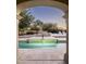 Stunning outdoor view of a well-designed pool and backyard area, framed by an arched opening at 19978 N 101St Pl, Scottsdale, AZ 85255