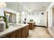 Bathroom with dual sinks, modern lighting, and beautiful countertops at 19978 N 101St Pl, Scottsdale, AZ 85255