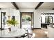 Elegant dining area with modern chandelier and views of the backyard pool and patio at 19978 N 101St Pl, Scottsdale, AZ 85255